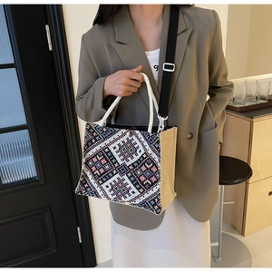 Ethnic woven tote bag with geometric patterns worn by a model in a retro setting