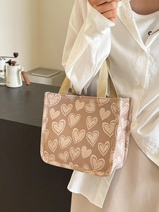 Graffiti heart print canvas tote bag with woven handles shown in a lifestyle scene