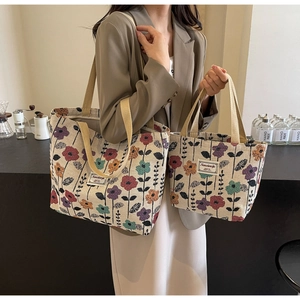 Detail shot of large and small vintage floral tapestry tote bags shown in a lifestyle setting