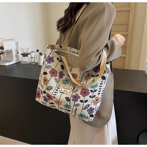 Detailed close-up of a floral jacquard canvas tote bag with retro patterns and woven handle