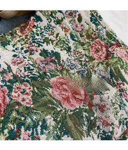 Close-up of heavy jacquard fabric showing red floral embroidery on a tote bag