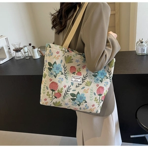 Detailed close-up of retro floral canvas tote bag with jacquard pattern and wide strap