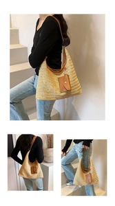 Detail of hand-woven straw tote bag with brown leather straps and decorative pouch