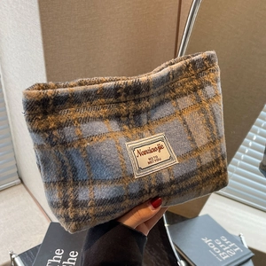 Detailed close-up of the vintage blue and yellow checkered fabric and Naniaojie woven label