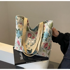 Detail of bohemian floral canvas tote with jacquard fabric and reinforced beige handles
