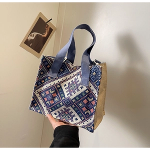 Detail of ethnic geometric pattern woven tote bag with durable canvas handles