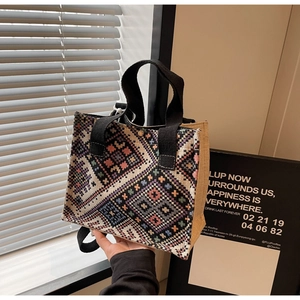 Close-up of ethnic geometric pattern weaving and canvas details on a crossbody bag