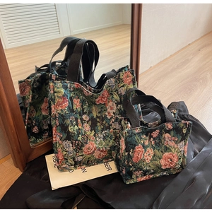Detailed view of jacquard floral tote bags in medium and small sizes on a mirror