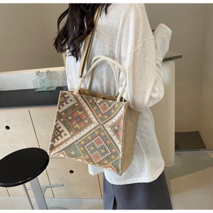 Detail of ethnic jacquard woven tote bag with colorful geometric patterns and rope handles