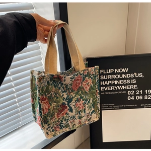 Detailed shot of ethnic floral jacquard tote bag with woven handles for casual style
