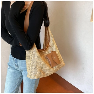 Detailed shot of large woven tote bag with brown leather straps and matching coin purse