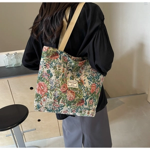 Detail of the vintage floral jacquard fabric and wide shoulder strap on this tote bag
