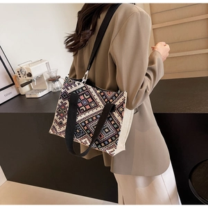Detailed shot of ethnic geometric woven canvas tote bag with adjustable wide strap