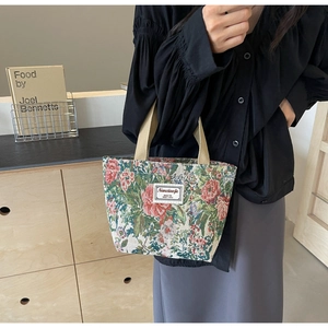 Detailed close-up of large floral jacquard tote bag with reinforced beige handles