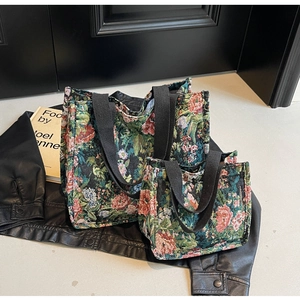 Detail showing two sizes of ethnic jacquard tote bags with floral patterns and woven handles