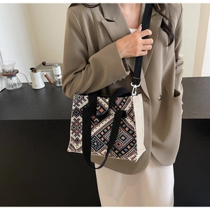 Detailed shot of ethnic jacquard canvas bag with geometric patterns and wide strap