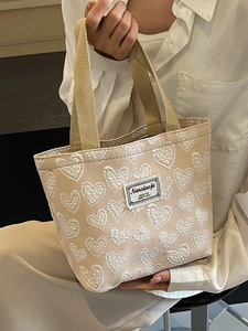 Beige canvas tote bag with white heart embroidery and retro tag for daily commute