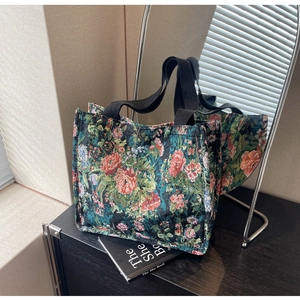 Detailed close-up of a floral jacquard tote bag with vibrant rose patterns and black handles