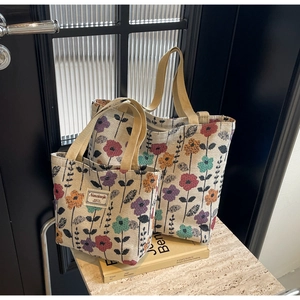 Detail of floral jacquard tote bag set with textured fabric and vintage embroidery pattern