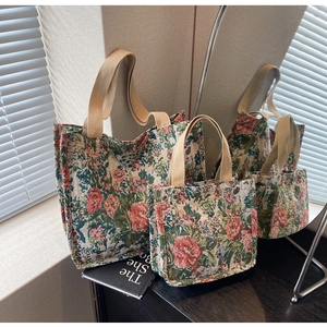 Detail view of large ethnic tote bags with floral patterns and sturdy woven straps