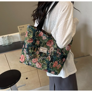 Detail of vintage floral jacquard tote bag featuring premium texture and woven label