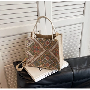 Detailed view of an ethnic woven linen tote bag with colorful geometric diamond patterns