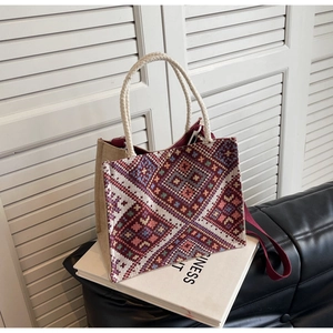 Detail of ethnic woven tote bag with geometric rhombus patterns and rope handles