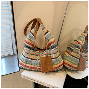 Detail of colorful striped woven tote bag with leather strap and mini charm purse
