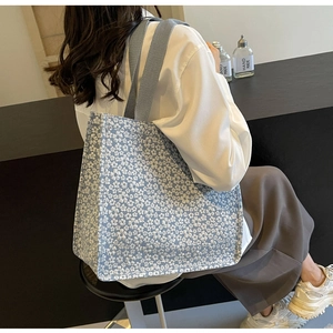 Detail of light blue floral canvas tote bag showing thick texture and fabric pattern