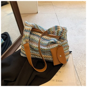 Detail of hand-woven tote bag showing zigzag wave pattern and leather handle and mini pouch