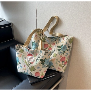 Detail of floral jacquard tote bags with thick woven straps and vintage tapestry pattern