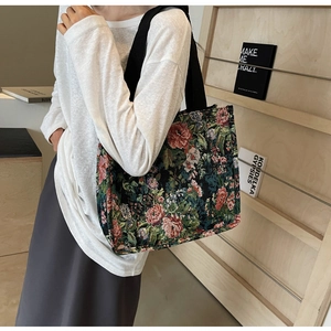Detail of vintage floral jacquard tote bag with wide black strap and rose embroidery