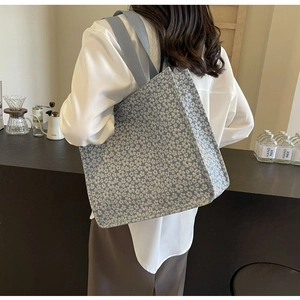 Detailed view of a floral canvas tote bag showing high-capacity design and sturdy straps