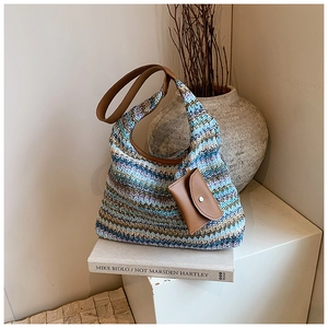 Detail of bohemian woven tote bag showing zigzag patterns and brown leather strap
