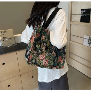 Macro view of vintage floral jacquard pattern and canvas handles on large tote bag