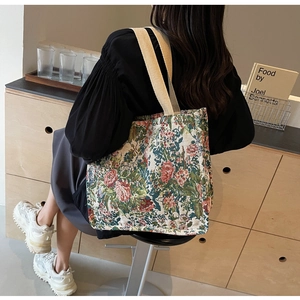 Detail view of ethnic floral jacquard tote bag with beige woven shoulder straps