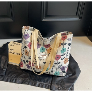Detail of canvas tote bag with retro floral patterns and branded woven label