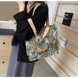Detailed macro view of ethnic style woven floral tote bag with sturdy beige wide straps