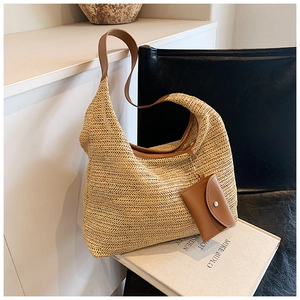 Close-up of handwoven tote bag featuring herringbone weave texture and brown leather strap