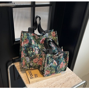 Detail view of large and small ethnic floral tote bags with retro oil painting texture