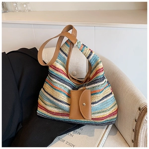 Detail of colorful striped woven hobo bag with leather strap and mini hanging purse