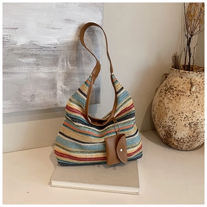 Detail of colorful woven tote bag with brown leather straps and detachable small coin purse
