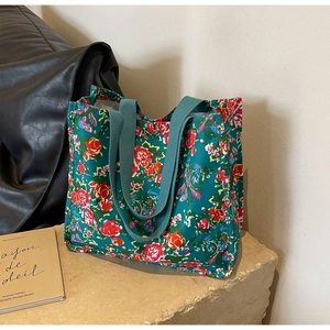 Détail du sac cabas en toile fleurie vintage montrant le tissu vert et les roses