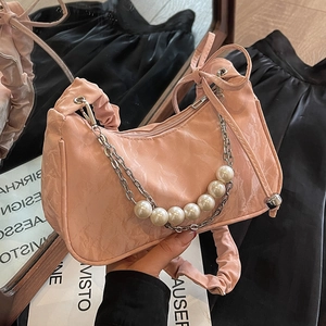 Pink pleated leather shoulder bag featuring decorative pearl and silver chain accents