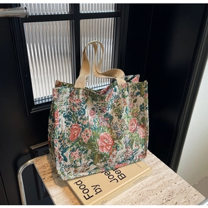 Detailed texture of ethnic floral jacquard fabric and durable cotton handle on tote bag