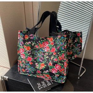 Detail view of ethnic floral tote bag with durable nylon fabric on a wooden background