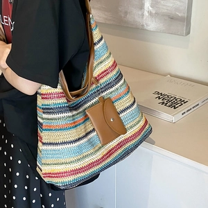 Large colorful striped woven tote bag with brown leather straps and small pouch charm