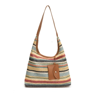 Colorful striped woven tote bag with brown leather handles and small hanging pouch for beach