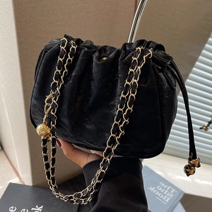 Elegant black velvet drawstring cloud bag with gold chain strap and metal ball adjuster
