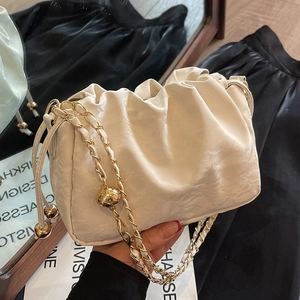 Chic cream pleated cloud bag with elegant gold chain strap and metal ball detail